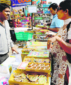 Residents buy crackers in Sector 26, Chandigarh, on Saturday. 