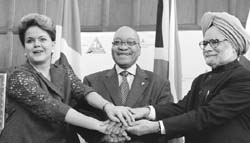 President Dilma Rousseff (L), South African Presidnt Jacob Zuma (C) and Indian Prime Minister Manmohan Singh posing during the IBSA summit in Pretoria.