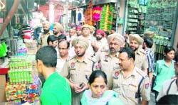 ACP Naresh Dogra along with police officials takes round of a crowded market in Jalandhar on Saturday.