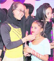  Students from Afghanistan being greeted with roses at the NCLP School at Shaheed Bhagat Singh Colony in Jalandhar on Saturday.
