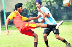 Players of MGM Dugri and Greenland School vie for the ball during a football match in Ludhiana.
