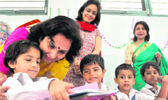 Vishal Chauhan, wife of Police Commissioner Dr SS Chauhan, helps a student prepare a poster for a smoke-free Diwali in Ludhiana