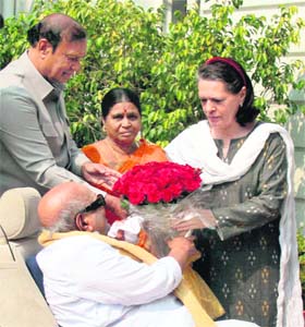 COURTESY CALL? DMK chief M Karunanidhi presents a bouquet to UPA chairperson Sonia Gandhi at her residence in New Delhi on Saturday. His wife and Kanimozhis mother Rajathi Ammal is also seen
