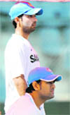 MS Dhoni (R) and Ajinkya Rahane watch proceedings during a practice session at The Wankhede Stadium in Mumbai