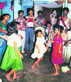Loudspeakers blare all night, spouting Hindi film songs, while madames and novices, children and grown-ups, pimps and babus, clients and relatives join in the revelry