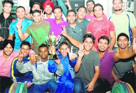 Winners of the weightlifting championship strike a pose with their trophy at the Sector-42 Sports Complex in Chandigarh on Sunday.