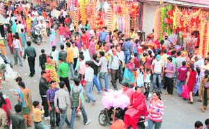 People throng the decorated Paltan Bazar for the Diwali shopping in Dehradun on Sunday