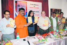 Eminent writer Ruskin Bond releases a book, Autumn Raga, by Jaskiran Chopra (third from left) at a function in Dehradun on Sunday. 