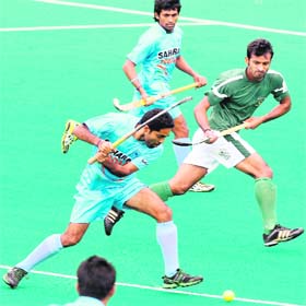 Indias Ravi Pal (L) hits the ball against Pakistan during their match at the International Super Series in Perth on Sunday