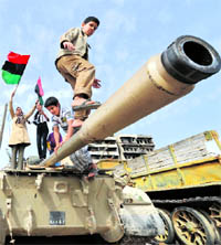 Libyan children play on a tank in Misrata on Sunday