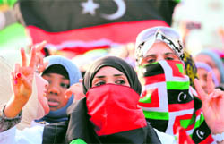 A woman flashes the victory sign as she takes part in celebrations following the official declaration of liberation of the entire country in Misrata on Sunday