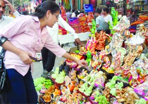 A girl buys idols of goddess Lakshmi on Dhanteras in New Delhi.