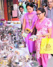 Women buy utensils on the occasion of Dhanteras at Dharamsala on Monday.