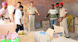 Police officials sieze crackers from a godwon in the Kot Sadeek area in Jalandhar on Monday.