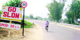 A file photo of two caution boards, one displaying 30 kmph as the speed limit and the old one (now removed) mentioning the limit of 50 kmph, near the Pohir chowk on the Ludhiana-Malerkotla road.