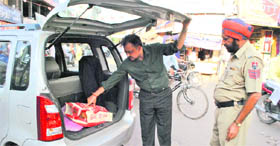 A police official checks vehicles as part of security drive ahead of Diwali in Patiala.