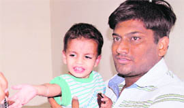 Kartik with his father at the Civil Hospital in Bathinda on Monday.