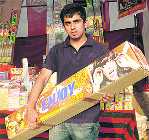 A city resident with a cracker worth Rs 5,000 at a market in Chandigarh on Diwali eve.