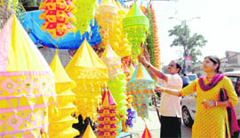 A buyer has a look at decoration items at a shop on the eve of Diwali in Dehradun on Tuesday.