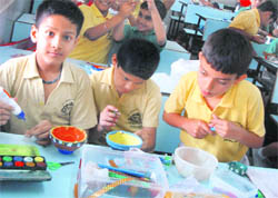Students of St Josephs Academy participate in a diya-making competition in Dehradun on Tuesday.