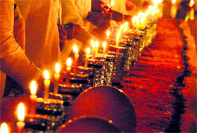 Members of an NGO lit candles on the eve of Diwali in Gurgaon.