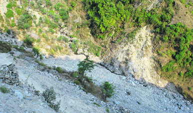 Landslides happening because of reckless cutting of hills by the Om Power Corporation pose a threat to the existence of Surad village.