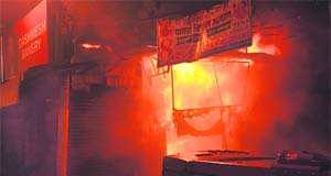Flames ooze out of a bakery at Laxmipura in Jalandhar on Wednesday night. 