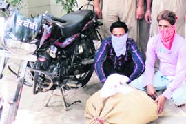 The accused with a bag of poppy husk in Jalandhar on Thursday. 