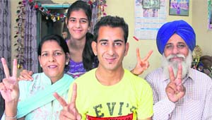Cricketer Satwinder Singh Vishu with his family members in Jalandhar on Thursday. 