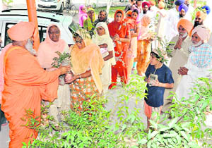Environmentalist Baba Balbir Singh Seechewal distributes saplings to residents on Wednesday.