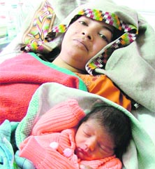 Meenakshi with her newborn son at the DMCH.