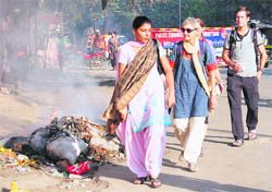 Participants in the Heritage Walk pass through a street littered with garbage in Amritsar on Friday. 