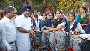 Deputy CM Sukhbir Badal distributing cycles to the girl students at the Government Girls Senior Secondary School at Mall road in Bathinda on Friday.