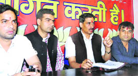 District chief of the Bharatiya Janata Yuva Morcha Naresh Sharma (second from right) at the party office in Haridwar on Friday. 