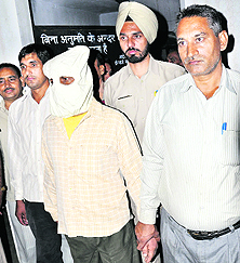 Surinder, who has been booked for making an attempt on the life of Additional Civil Judge Hem Raj Verma, in police custody in Karnal on Friday. 