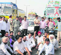 BSP activists block traffic on the national highway in Phagwara on Friday.
