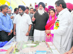 CM Parkash Singh Badal flanked by his son and Dy CM Sukhbir Badal and daughter-in-law and MP Harsimrat Kaur, inspects the model of the proposed cancer hospital in Bathinda on Friday