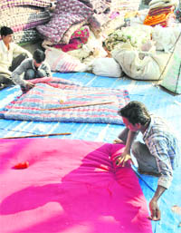 A quilt maker gives the final touches to a quilt at the Nabha Gate in Patiala on Friday.  