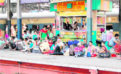 Passengers wait on a platform at the Amritsar railway station on Saturday