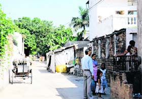 A temporary structure and a parked rickshaw in one of the back lanes of Sector 18