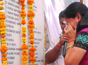 An relative of a Sarojini Nagar bomb blast victim breaks down during an event to mark its 6th anniversary in New Delhi on Saturday. 