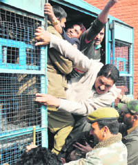 The police detains protesting employees of the Jammu and Kashmir Government Urban Local Bodies in Srinagar on Saturday. 