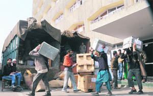 Labourers carry official files and documents in Srinagar on Saturday during the bi-annual darbar move to Jammu
