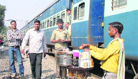 A vendor sells eatables to stranded passengers at Phillaur on Saturday.