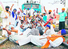 Activists of various farmers and labour unions block rail traffic in Amritsar on Saturday.