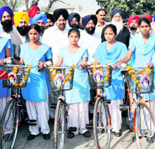 Chief Minister Parkash Singh Badal distributes bicycles to girl students during a Sangat Darshan programme in Kapurthala on Saturday.