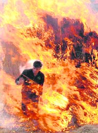 Magician CP Yadav runs in fire during a performance in Faridabad on Sunday