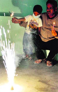 A boy bursts crackers in Rajpura