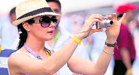 Actress Priety Zinta busy clicking pictures during the drivers parade for the Indian Formula One Grand Prix at the Buddh International Circuit in Greater Noida on Sunday.