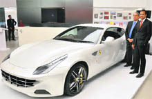 Ferrari SpA CEO Amedeo Felisa (L) and Ashish Chordia, chairman the Shreyans group, the Italian sports car manufacturers official importer for India, pose next to Ferraris four-seater FF model at its launch in New Delhi on Monday. The cars price starts from Rs 3.42 crore (ex-showroom, Delhi).